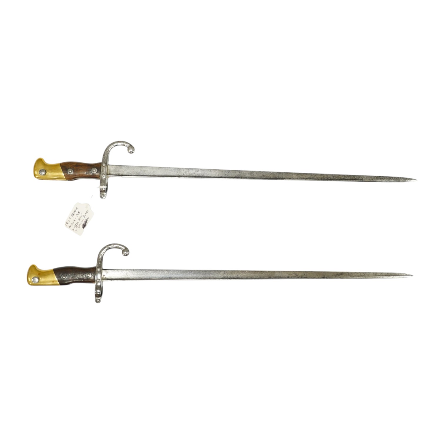 Two French Gras bayonets; a bayonet with a T-section blade dated 1877, and another almost identical blade dated 1879, scabbards missing. Condition - good